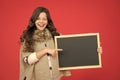 Just look here. happy girl hold empty blackboard. copy space. write your information here. place for advertisement. back