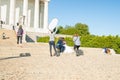 Just married couple being photographed on step of Lincoln Memorial in beautiful fine day
