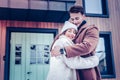 Just married couple hugging standing outside their new house Royalty Free Stock Photo