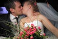 Just married couple kissing in limousine Royalty Free Stock Photo