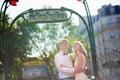 Just married couple with Parisian metro sign