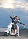 Just married couple ride white scooter Royalty Free Stock Photo