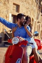 Just married couple riding motor scooter in city street Royalty Free Stock Photo