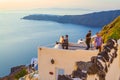 Just married couple on the rooftop Santorini Caldera cliff face Greece