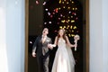 Just married couple under a rain of flower petals Royalty Free Stock Photo