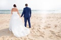 Just married couple walk on fence by the beach Bride and groom Royalty Free Stock Photo