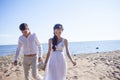 Just married happy couple running on a sandy beach Royalty Free Stock Photo