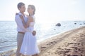 Just married happy couple running on a sandy beach Royalty Free Stock Photo