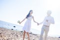 Just married happy couple running on a sandy beach Royalty Free Stock Photo