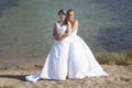 Just married happy lesbian couple in white dress embrace near sm