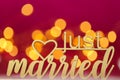 just married inscription. .wedding symbol on a bright pink fuchsia background with golden bokeh