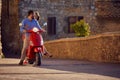 Just married man and woman riding motor scooter in city Royalty Free Stock Photo