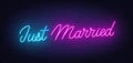 Just Married neon lettering on brick wall background.