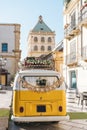 Just married sign in classic yellow vintage van with picturesque village in the background. Royalty Free Stock Photo