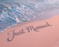Just Married Text Written on Beach Sand with Ocean Waves Royalty Free Stock Photo