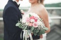 Just married wedding couple posing and bride holding in hands bouquet Royalty Free Stock Photo