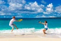 Just married young happy loving couple having fun on the tropical beach Royalty Free Stock Photo