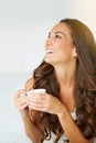 Just me and my cuppa. a young woman drinking a coffee on her bed.