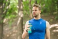 Just a minute to rest. Man athletic appearance holds bottle with water. Man athlete in sport clothes cares about water