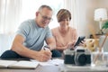 We just need to save a little more. a mature couple calculating their budget together. Royalty Free Stock Photo