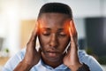 He just needs a moment to gather his thoughts. a young and stressed businessman suffering from a headache while trying Royalty Free Stock Photo