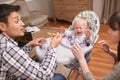 Just one more bite, my little angel. A young father feeding his daughter some baby food. Royalty Free Stock Photo