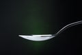 just perfect metal spoon on dark background .