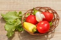 Just picked tomatoes and yellow bell pepper in a wicker basket w Royalty Free Stock Photo