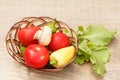 Just picked tomatoes and yellow bell pepper in a wicker basket w Royalty Free Stock Photo