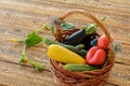 Just picked vegetables in wicker basket on old wooden boards Royalty Free Stock Photo