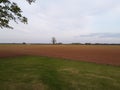 Just planted field with corners meeting of grass and brown field