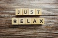 Just Relax alphabet letters on wooden background