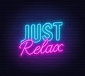 Just Relax neon lettering on brick wall background