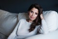 Just relaxing at home. Portrait of a beautiful young woman relaxing on her sofa at home. Royalty Free Stock Photo