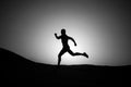 Silhouette or man runner, guy running outdoor at clear sky Royalty Free Stock Photo