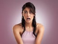 Just say yikes and move on. a beautiful young woman looking shocked against a pink background.