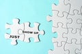 Just show up words on two pieces of white jigsaw puzzle on blue background. Royalty Free Stock Photo