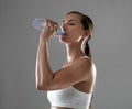 Just a sip, then back to work. a woman rehydrating during a strenuous workout.