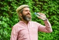 Just smile. bearded man hold plastic bottle of water. feeling thirsty. drink some water while walking in park. get
