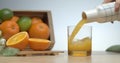 Just squeezed fresh orange juice pouring in glass to have breakfast. Royalty Free Stock Photo