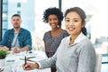 Just taking note of some of our best ideas. Portrait of a young businesswoman sitting in a meeting with her colleagues Royalty Free Stock Photo