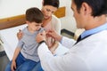 Just a teeny, tiny bit of ouch. Aerial shot of a doctor placing a plaster on his patients arm.