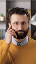 Just think gesture emotion. Vertical view of positive bearded man teacher or businessman with glasses looking at camera