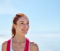 Just thinking about a workout makes her smile. a sporty young woman on the beach. Royalty Free Stock Photo