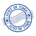 JUST IN TIME, text written on blue postal stamp Royalty Free Stock Photo