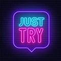 Just Try neon sign in the speech bubble on brick wall background.