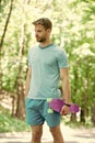 Just try ride once and you will love it. Guy carries penny board ready to ride. Man serious face carries penny board Royalty Free Stock Photo