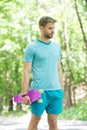 Just try ride once and you will love it. Guy carries penny board ready to ride. Man serious face carries penny board Royalty Free Stock Photo