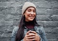 Just a typical city girl. Cropped portrait of an attractive teenage girl standing against a gray wall in the city and