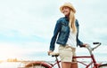 Just waiting for the cars to come past. a cheerful young getting ready to ride her bicycle while looking in a certain Royalty Free Stock Photo